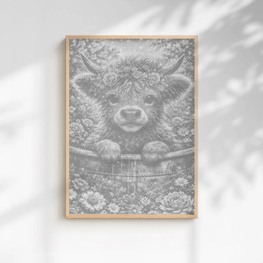 Framed artwork of a cow's face on a white wall with soft shadows. Blossom Highland Cow | Dot Painting Kit