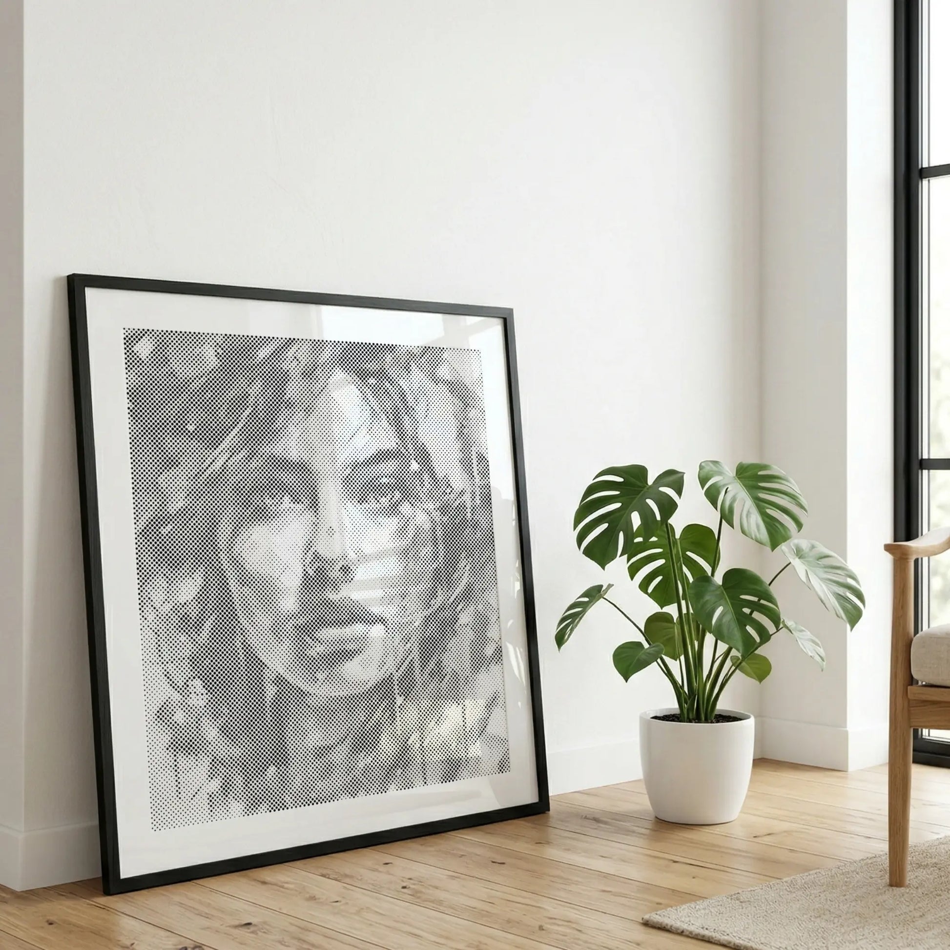 Framed black and white portrait on a wall with a plant and chair in the background Modern Woman Portrait | Dot Painting Kit